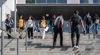 students walking to and from class by the Los Angeles Southwest College library