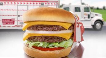 in-n-out double double burger in front of in-n-out truck