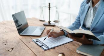 person conducts business in front of legal scale