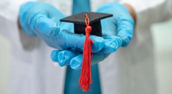 Asian doctor study learn with graduation gap hat in hospital ward, clever bright genius education medicine concept.