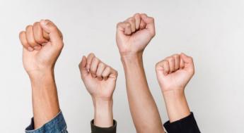 fist raised in front of white background