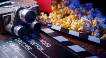 movie popcorn next to film camera and production marker