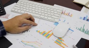 spreadsheets on table under mouse and keyboard