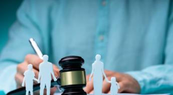 judges gavel behind paper cut out family