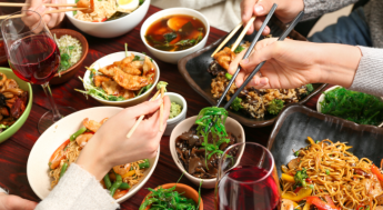 asian food items on table with people using chopsticks to enjoy
