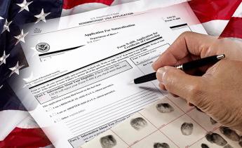 Man with American citizenship application on USA flag