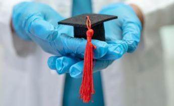 Asian doctor study learn with graduation gap hat in hospital ward, clever bright genius education medicine concept.
