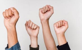 fist raised in front of white background
