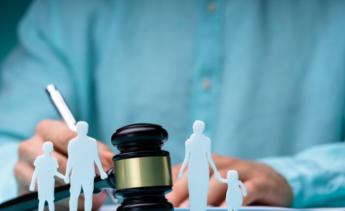judges gavel behind paper cut out family