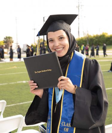 Female Student Holding her Diploma