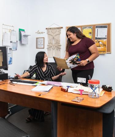 Coworkers Talking in Desk