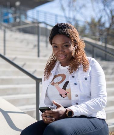 Female Student with Phone on Stairs