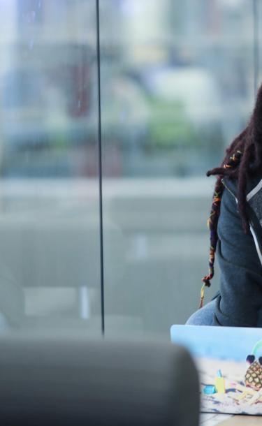 Student in Front of Window with Computer