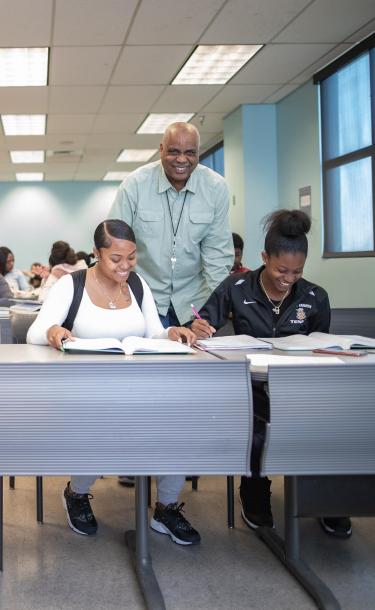 Professor with Students Explaining at Class