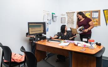 Coworkers Talking in Desk