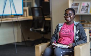 Girl Student with Glasses Sitting at Library