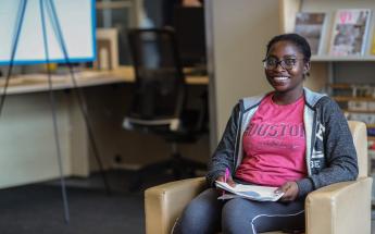 Girl Student with Glasses Sitting at Library 