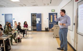 Professor Talking in Classroom in Front of the Students