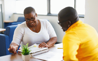 Rise counselor sits with student