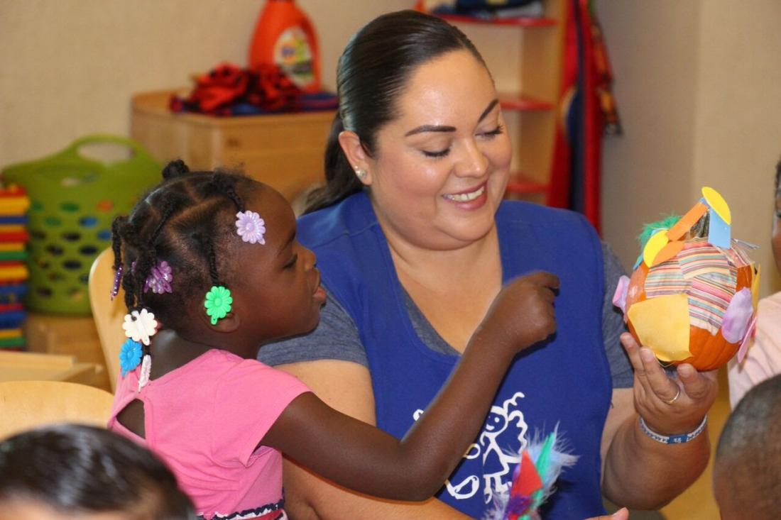 Kindergarten Teacher Helping Students