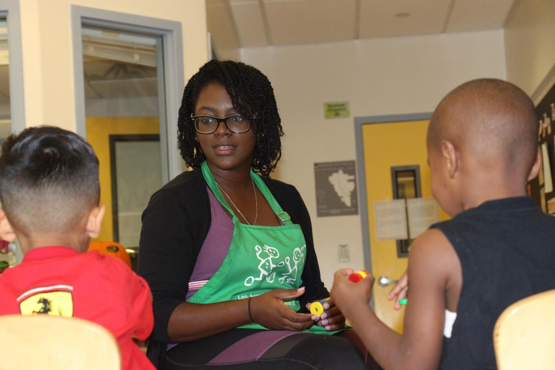 Woman Talking to Two Children