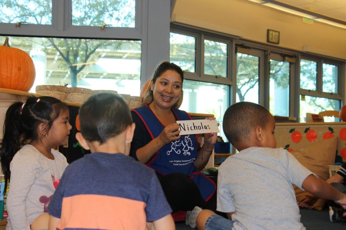 Teacher Holding a Sign with Name