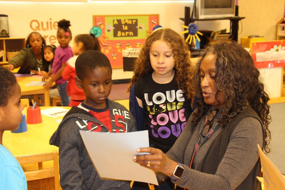 Woman Showing a Document to Two Children