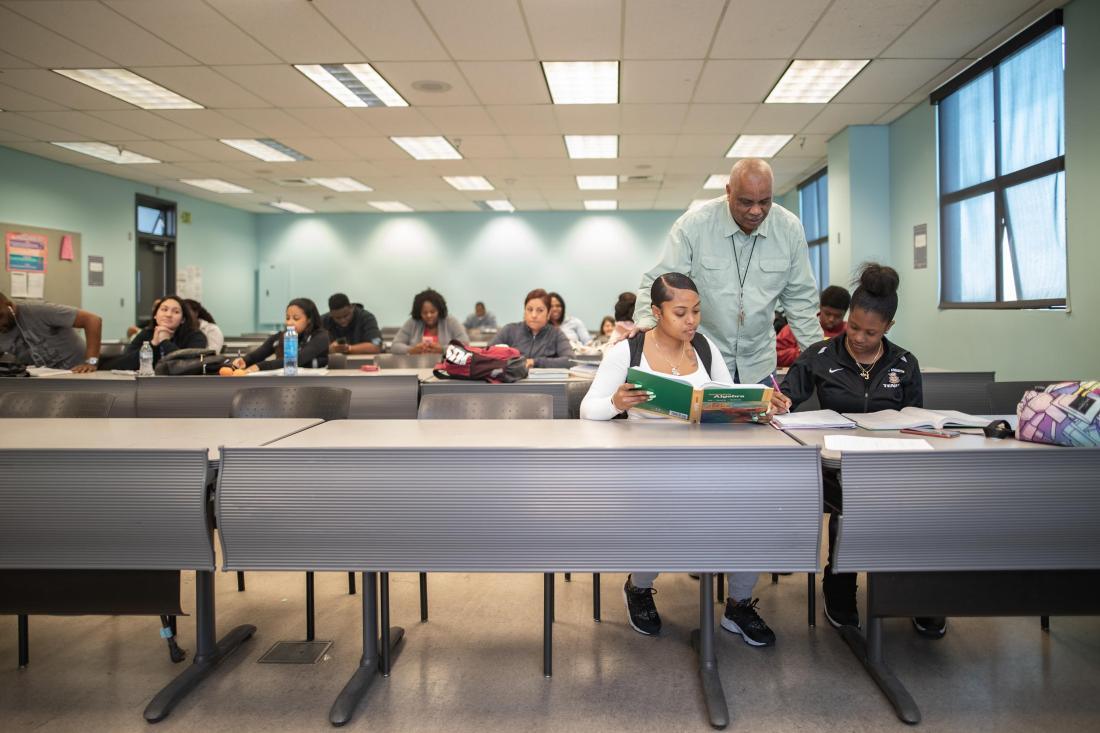 Teacher Helping a Pair of Students