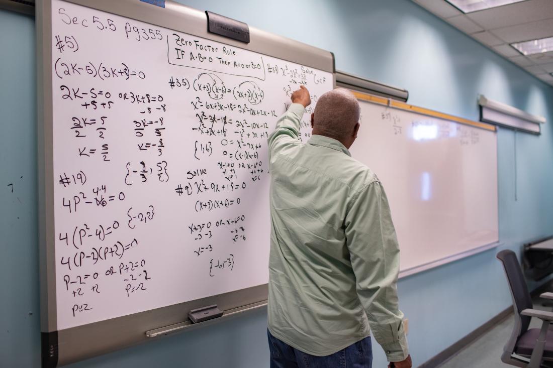 Teacher Explaining an Exercise on the Blackboard