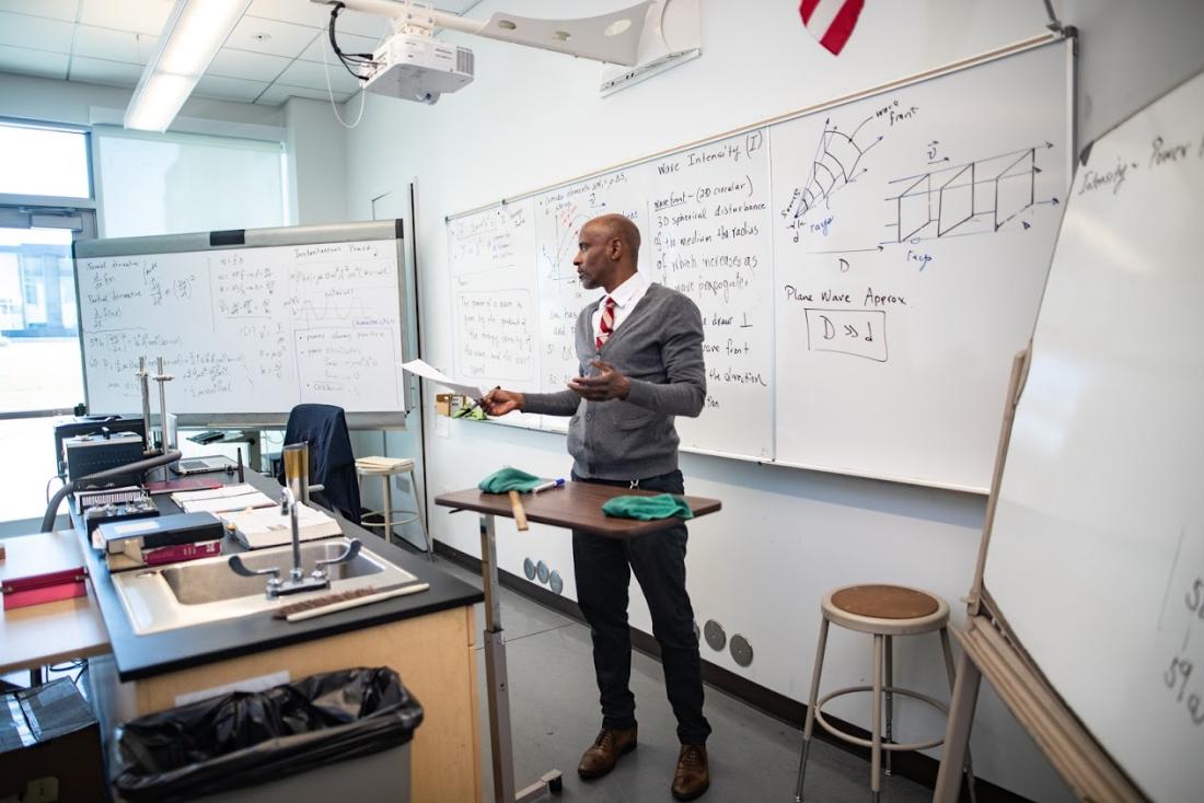 Teacher Lecturing in Front of Whiteboard