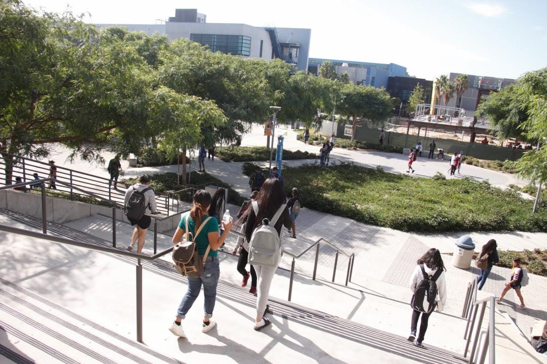 Students Walking on Campus Stairs