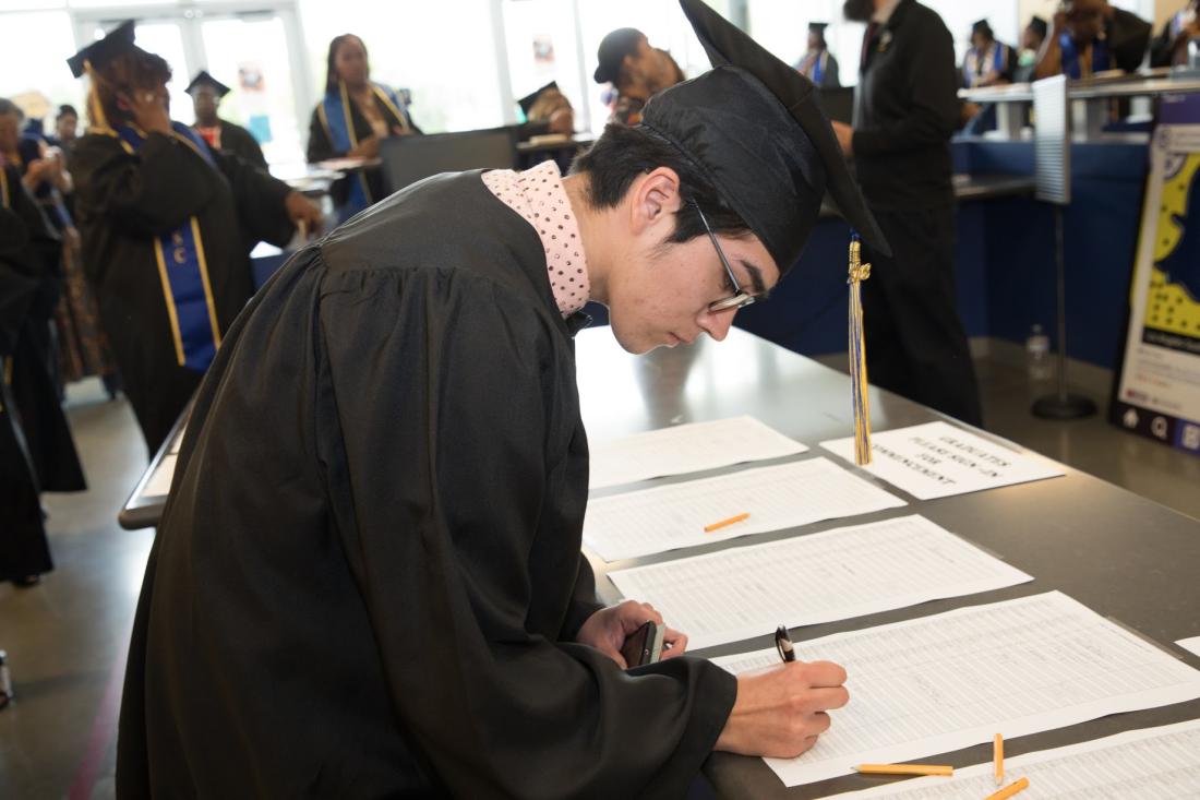Student Signing in Graduation