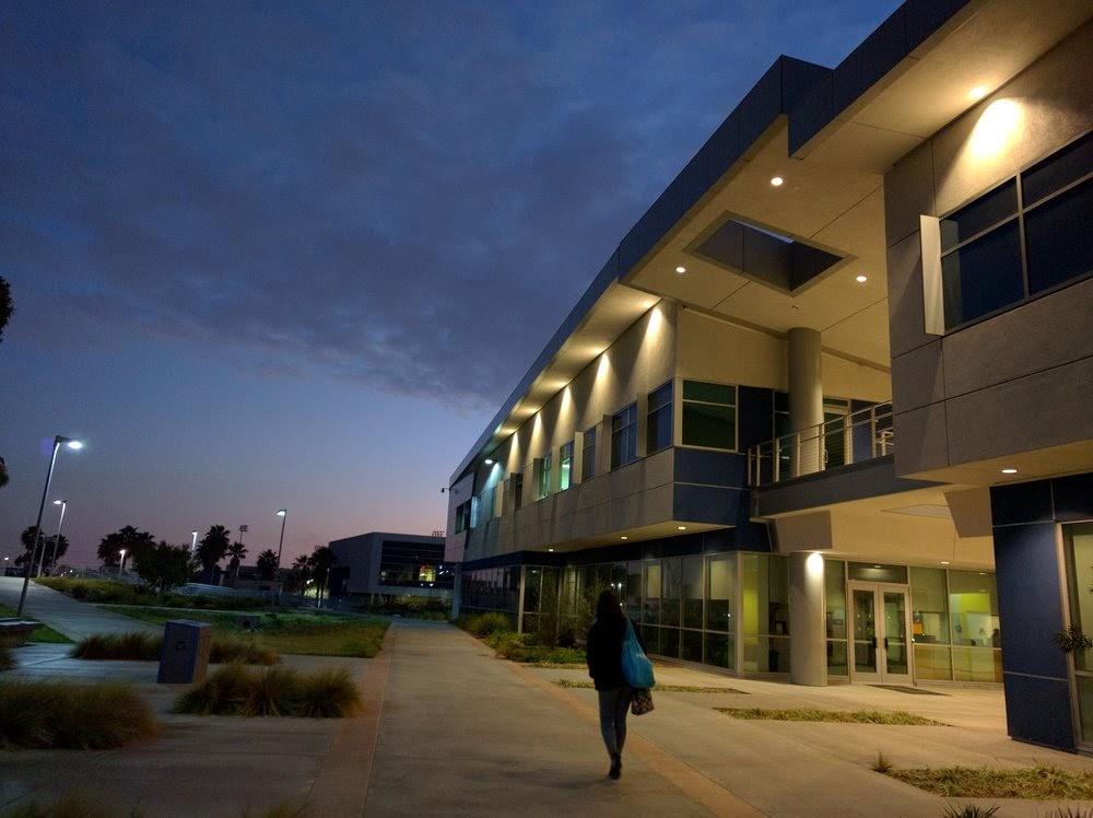 Student Walking Past Building