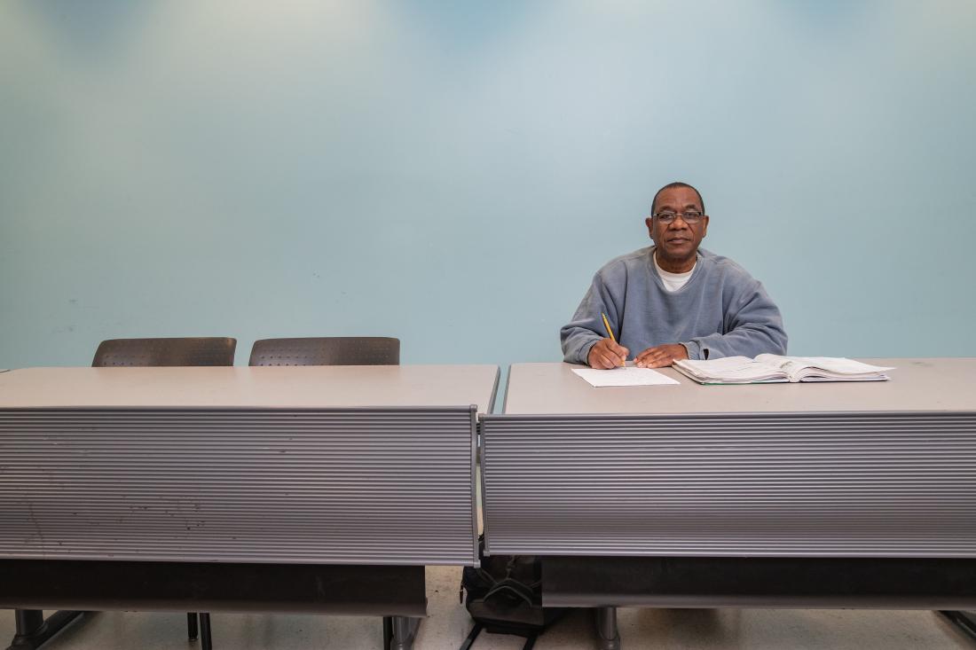 Teacher Seated at Desk