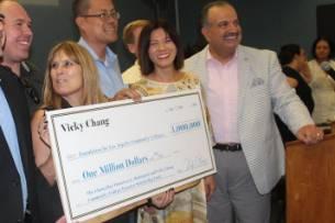 Vicky Chang Holding a Check with a Group of People 