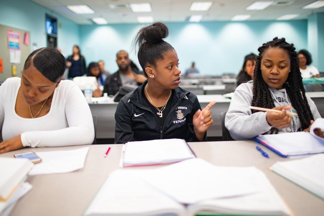 Female Students Taking Notes at Class 