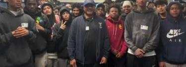 LASC football team in street clothes with Coach Jenkins in center